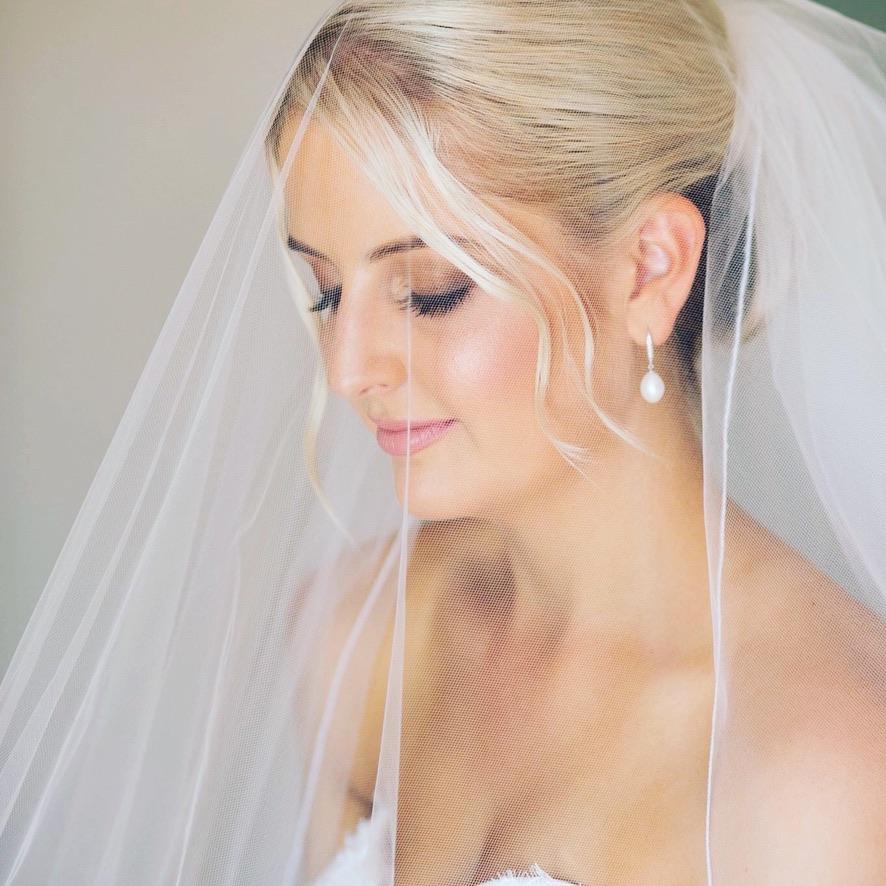 Natural, glowing bride with veil. Defined eyes, glowing skin and soft lips.