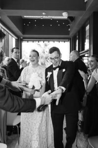 Wedding Day photo of beautiful bride and groom greeting guests.